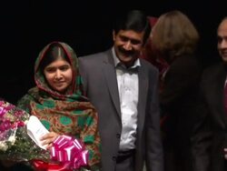Malala Yousafzai Standing On Stage With Flowers News Clip