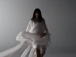 woman draped with silk backs away from camera Stock Footage