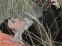 Mature woman reading book and relaxing on beach Stock Footage