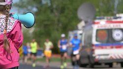 Girl cheering runners by megaphone in 4k slow motion 60fps Stock Footage