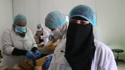 Refugee women earn money making school lunches Instructional Video