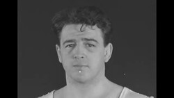 Boxers Max Baer and Joe Louis in gym wearing suits and goofing around with equipment; Al McCoy shadow boxing News Clip