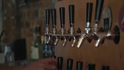 Bar worker polishing beer taps in a craft beer pub News Clip