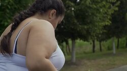 Fat girl runs along the road Stock Footage