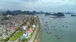 4k Aerial view over city and park with Bai Tho karst mountain Ha long bay. Halong City. Stock Footage
