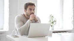 Pensive Businessman Thinking and Working on Laptop Stock Footage