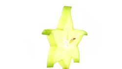 One star shaped slice of ripe carambola fruit. Rotating on the turntable isolated on the white background. Close up. Macro. Stock Footage
