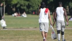 People relaxing and excercising in London Fields on a sunny day News Clip