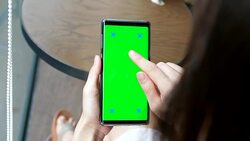 Young woman uses smartphone with green screen Stock Footage