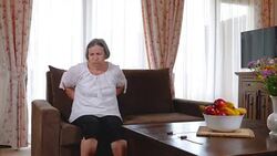 Senior woman suffering from backache at home Stock Footage