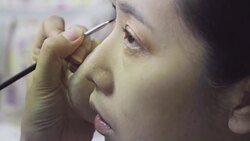 Professional make-up artist making up her model face Stock Footage