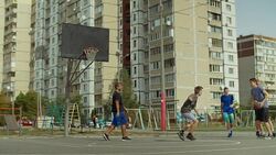 Streetball players playing basketball on court Stock Footage