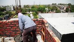 Bricklayer installing bricks on construction site Stock Footage