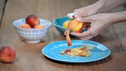 Female hands peeling a blanched peach. Stock Footage
