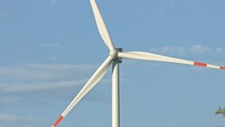 Wind turbines and agricultural fields on a summer day Stock Footage