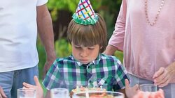 Grandparents kissing their beloved birthday grandson in cheeks, happiness Stock Footage