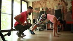 Young athletic woman warming up with a personal trainer Stock Footage