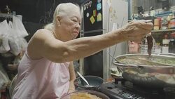 Senior Asian woman eating Suki or Shabu boiling in electric pot with turnips, pork chops, squid, corn, vermicelli and pork.Concept of: love, food, Asian food. Stock Footage