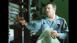 UNITED STATES 1960s: Hands put plate on roller / Papers in press. Stock Footage