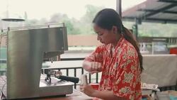 Young woman using coffee grinder at home. Stock Footage