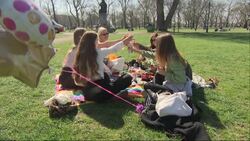People sitting and relaxing on Clapham Common News Clip