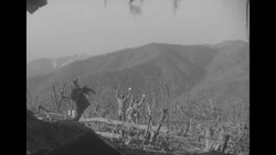 During Korean War, US soldier takes two North Korean soldiers prisoner during Battle of Bloody Ridge in North Korea News Clip