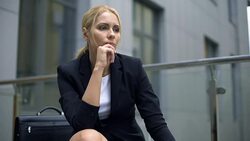 Pensive businesswoman sitting on bench, worried about troubles at work, stress Stock Footage