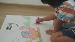 Boy is drawing and crayon of dinosaur Stock Footage