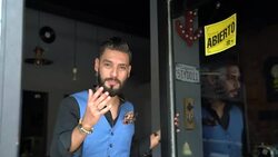 Happy barber opening door and welcoming customer Stock Footage