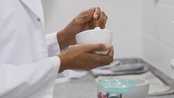 Pharmacist mixing medicine in mortar and pestle Stock Footage