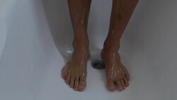 Man standing in public shower with bare feet, hygiene, risk to pick up fungus Stock Footage