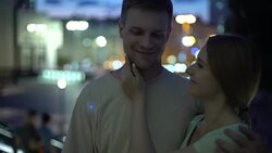 Young couple hugging against night city background, sense of reliability comfort Stock Footage