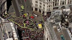 Aerials of police surrounding the pink Extinction Rebellion yacht News Clip