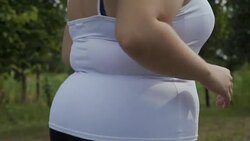Fat girl runs along the road Stock Footage
