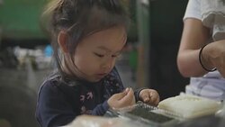 Happy Asian baby girl eating food at home. feed by her mom. Concept : Food,Family,life. Stock Footage