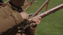Colonial soldier getting musket ready to fire Stock Footage