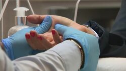 Beautician at work with COVID safety measures in place News Clip