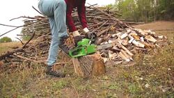 Lumberjack fixing / maintain the chainsaw outdoors. Stock Footage