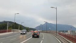 Driving on the highway by the mountain range Stock Footage