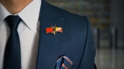 Businessman Walking Towards Camera With Friend Country Flags Pin China - Bhutan Stock Footage