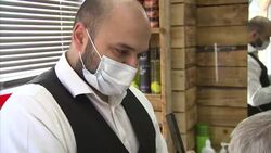 Men having haircuts in a barbers' after lockdown easing News Clip