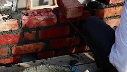 Bricklayer installing bricks on construction site Stock Footage
