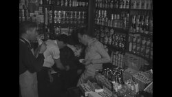 Young men gather around radios to listen to US military draft numbers News Clip