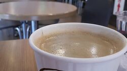 Blur motion of hot coffee with steam on table inside restaurant Stock Footage