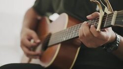 Guitarist is playing guitar while using capo Stock Footage