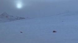EST WIDE ANGLE OF SNOW COVERED MOUNTAIN. PEAK OF SECOND MOUNTAIN IN BACKGROUND. COULD BE HIMALAYAS. THREE PEOPLE HUDDLED IN CIRCLE. SEE ANIMAL IN SNOW TO LEFT. COULD BE DEAD HORSE. WINTER. Stock Footage