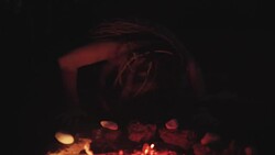 Scary witch does voodoo black magic ritual near the fire at night. Halloween horror Stock Footage