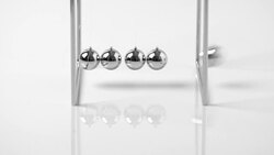 4k Newtons Cradle balancing balls, business concept in studio Stock Footage