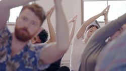 Serene creative business people practicing yoga in office Stock Footage