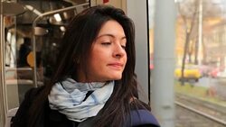 Woman riding train looking out window in 4K Stock Footage